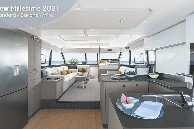  Yacht Photos Pics Luxurious interior of 2025 Fountaine Pajot MY6 yacht with modern kitchen and seating area.
