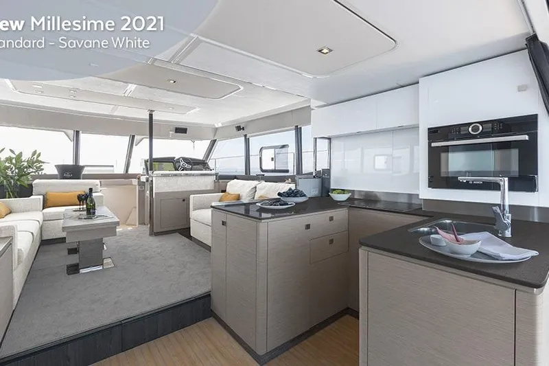  Yacht Photos Pics Luxurious interior of 2025 Fountaine Pajot MY6 yacht with modern kitchen and seating area.
