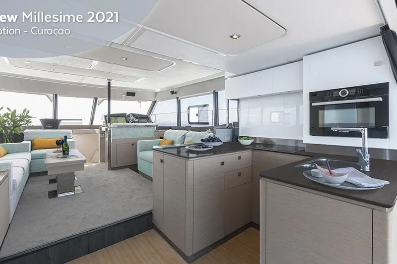  Yacht Photos Pics Luxurious interior of 2025 Fountaine Pajot MY6 yacht with modern kitchen and seating area.