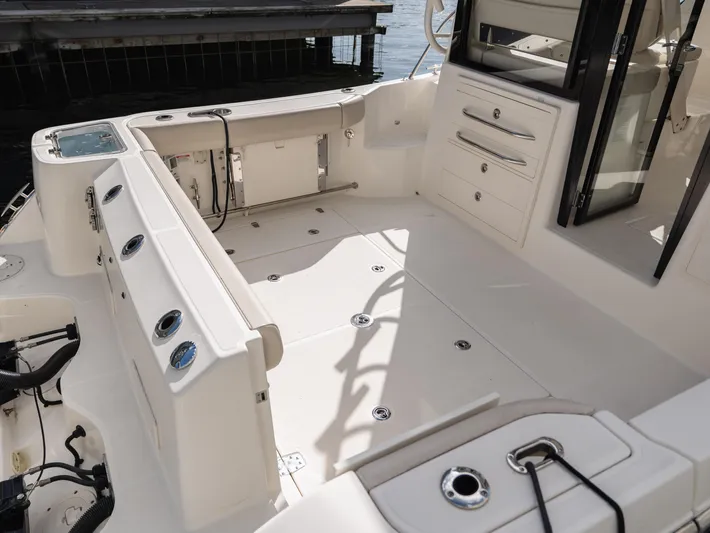  Yacht Photos Pics 2020 Boston Whaler 325 Conquest Pilothouse boat interior with spacious deck and storage compartments.