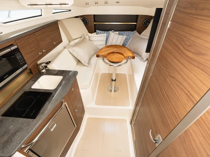  Yacht Photos Pics Interior of 2020 Boston Whaler 325 Conquest Pilothouse with modern kitchen and cozy seating area.