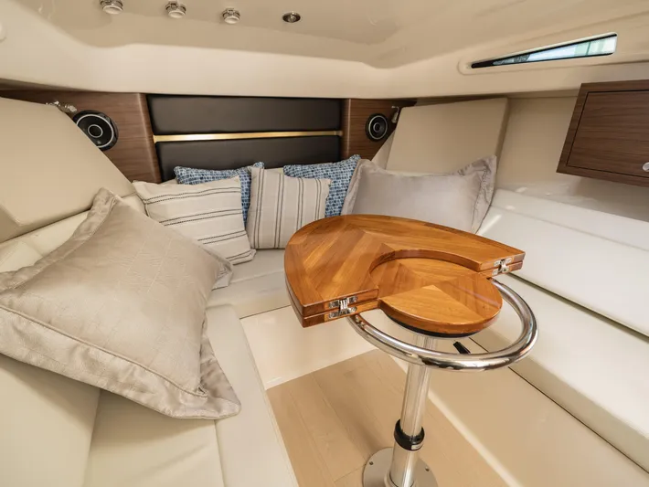  Yacht Photos Pics Luxurious interior of 2020 Boston Whaler 325 Conquest Pilothouse with elegant seating and wooden table.
