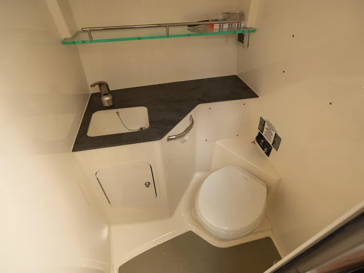  Yacht Photos Pics Bathroom interior of 2020 Boston Whaler 325 Conquest Pilothouse with sink and toilet.