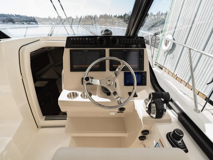  Yacht Photos Pics 2020 Boston Whaler 325 Conquest Pilothouse helm with modern controls and navigation screens.