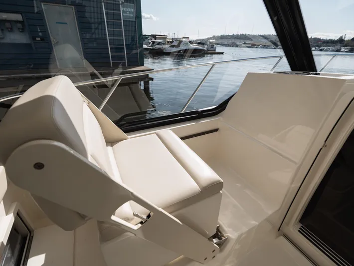  Yacht Photos Pics 2020 Boston Whaler 325 Conquest Pilothouse interior with waterfront view.
