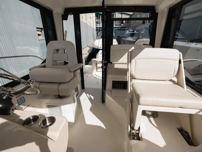  Yacht Photos Pics 2020 Boston Whaler 325 Conquest Pilothouse interior with plush seating and modern helm.