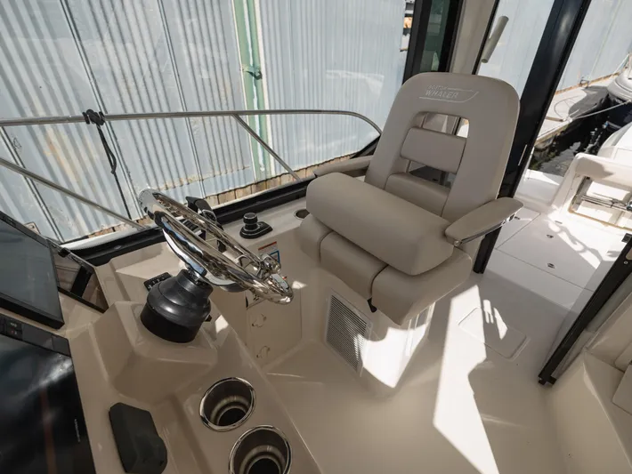  Yacht Photos Pics 2020 Boston Whaler 325 Conquest Pilothouse helm with steering wheel and captain's chair.