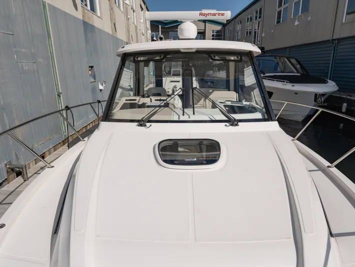 Yacht Photos Pics 2020 Boston Whaler 325 Conquest Pilothouse boat docked, showcasing sleek design and pilothouse.