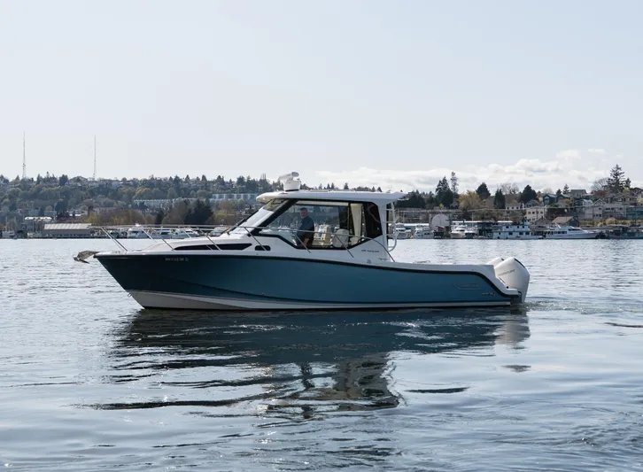  Yacht Photos Pics 2020 Boston Whaler 325 Conquest Pilothouse cruising on calm waters.