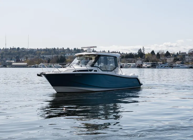  Yacht Photos Pics 2020 Boston Whaler 325 Conquest Pilothouse on calm water, scenic background.