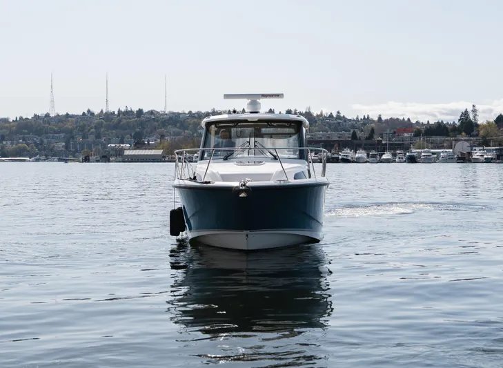  Yacht Photos Pics 2020 Boston Whaler 325 Conquest Pilothouse on calm water, front view.