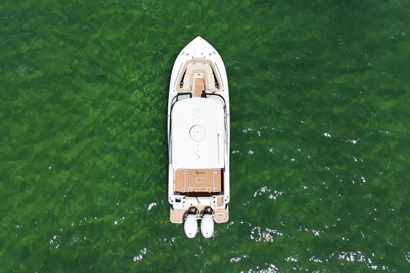  Yacht Photos Pics Aerial view of 2022 Scout 277 Dorado boat on green water.
