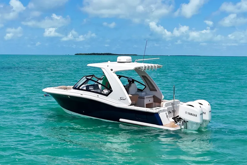  Yacht Photos Pics 2022 Scout 277 Dorado boat cruising on turquoise ocean waters.
