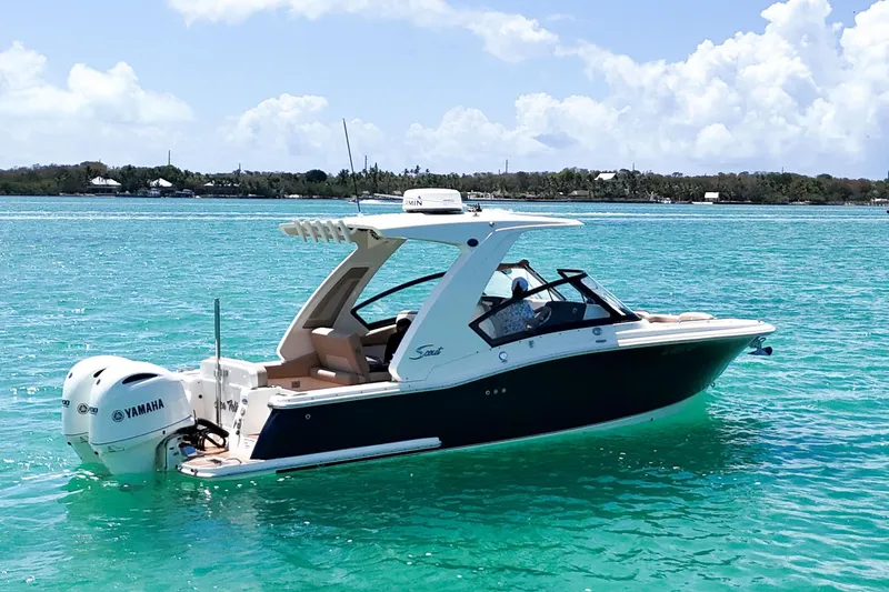  Yacht Photos Pics 2022 Scout 277 Dorado boat on turquoise water with Yamaha engine.