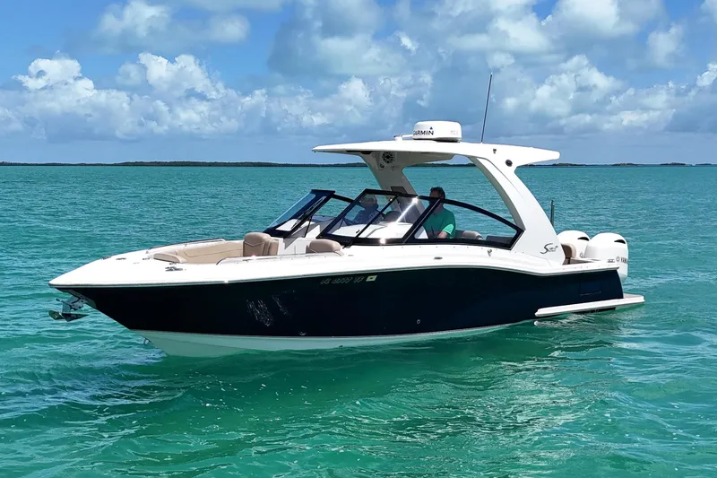  Yacht Photos Pics 2022 Scout 277 Dorado boat cruising on turquoise water under a clear sky.