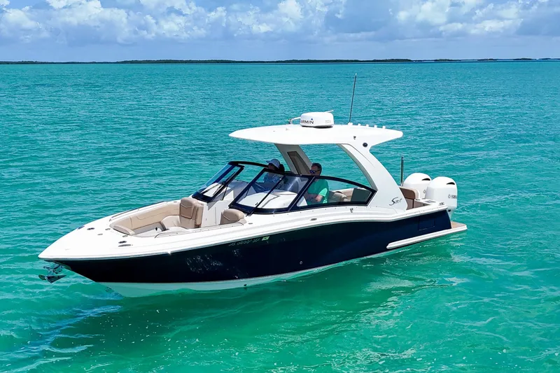  Yacht Photos Pics 2022 Scout 277 Dorado boat cruising on clear turquoise water.