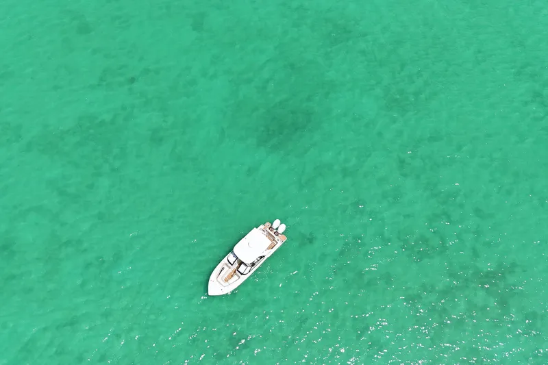  Yacht Photos Pics Aerial view of 2022 Scout 277 Dorado boat on clear turquoise water.