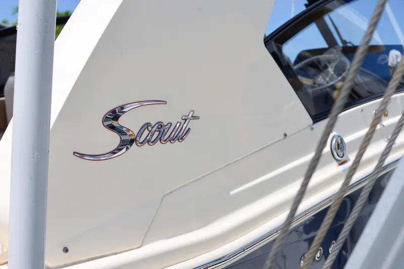  Yacht Photos Pics 2022 Scout 277 Dorado boat side view with logo and sleek design.