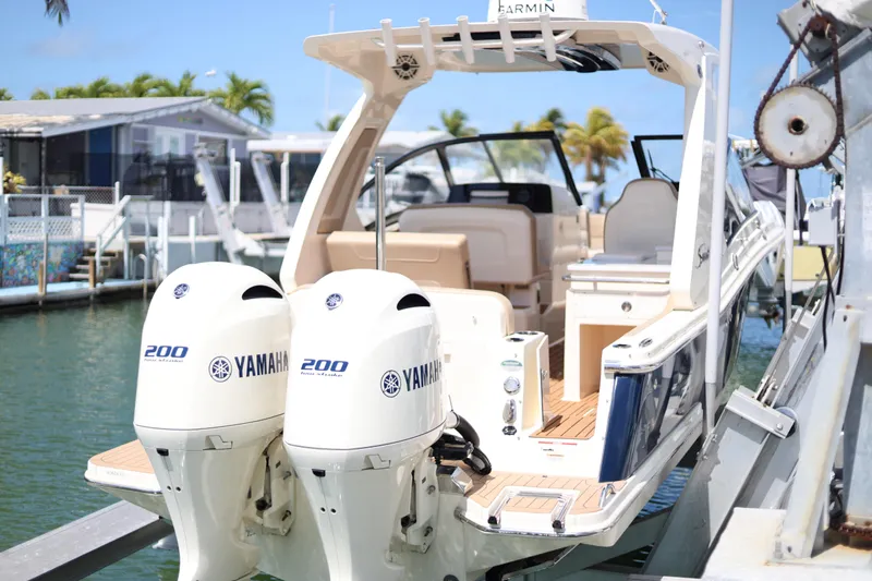  Yacht Photos Pics 2022 Scout 277 Dorado boat with twin Yamaha 200 engines docked in marina.