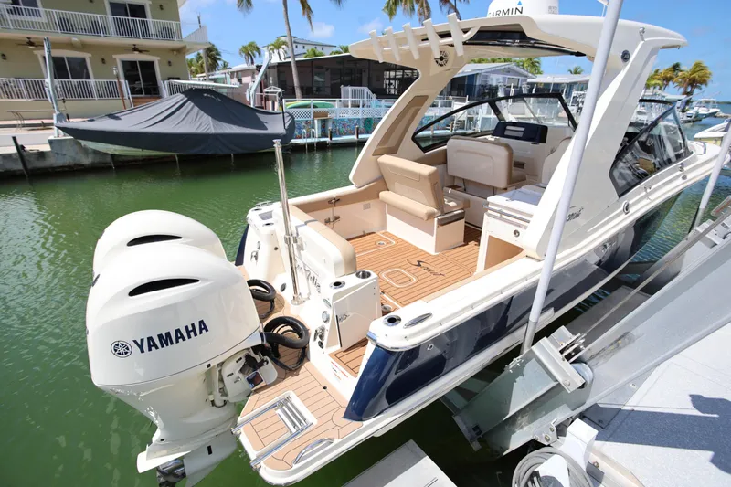  Yacht Photos Pics 2022 Scout 277 Dorado boat with Yamaha engines docked in a marina.