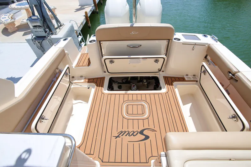  Yacht Photos Pics 2022 Scout 277 Dorado boat interior with teak flooring and storage compartments.