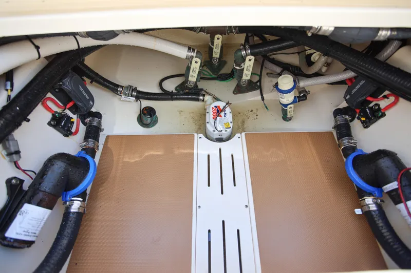  Yacht Photos Pics Engine compartment of 2022 Scout 277 Dorado boat, showcasing hoses and mechanical components.