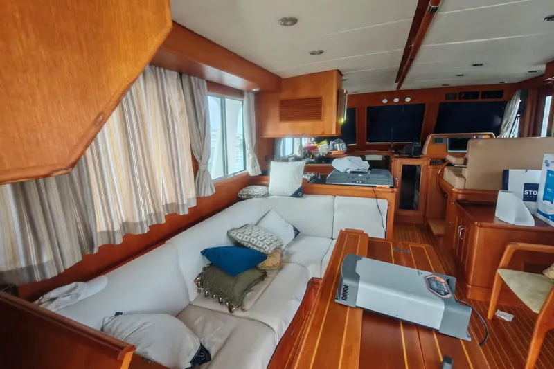 Sesaccia Yacht Photos Pics Interior of 2007 Grand Banks 47 Europa yacht with wooden furnishings and cozy seating area.