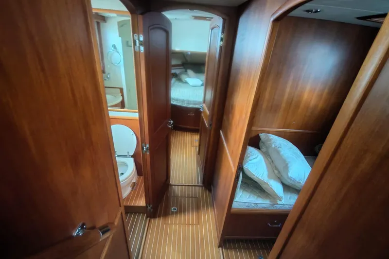 Sesaccia Yacht Photos Pics 2007 Grand Banks 47 Europa interior with wooden finish, featuring a cozy cabin and bathroom.