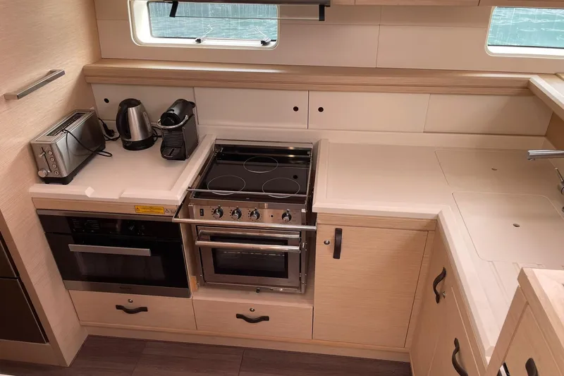  Yacht Photos Pics Modern kitchen in 2017 Jeanneau 64 yacht with stove, oven, and appliances.