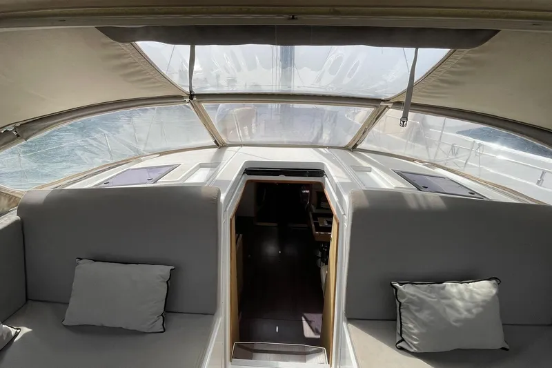  Yacht Photos Pics Interior view of 2017 Jeanneau 64 yacht with comfortable seating and open hatch.