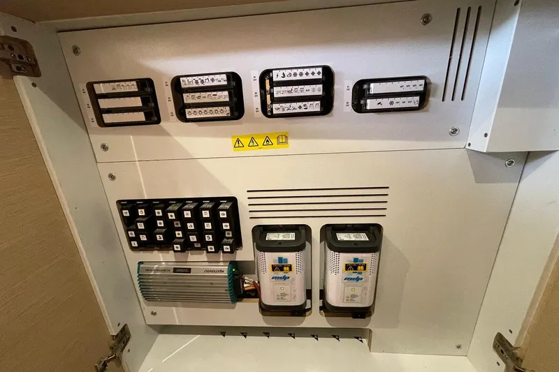  Yacht Photos Pics Electrical panel of a 2017 Jeanneau 64 yacht, featuring various switches and components.