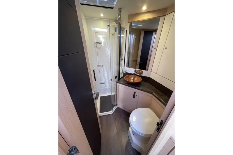  Yacht Photos Pics Luxurious bathroom in 2017 Jeanneau 64 yacht with modern fixtures and elegant design.