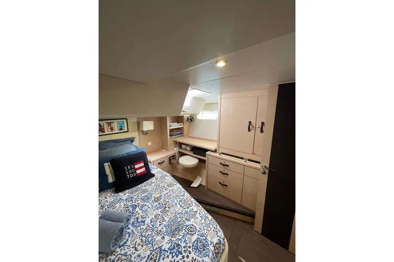  Yacht Photos Pics Luxurious interior cabin of 2017 Jeanneau 64 yacht with elegant bedding and storage.