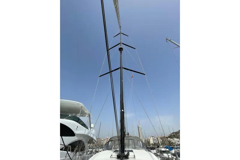  Yacht Photos Pics Mast of 2017 Jeanneau 64 yacht against clear blue sky in marina.