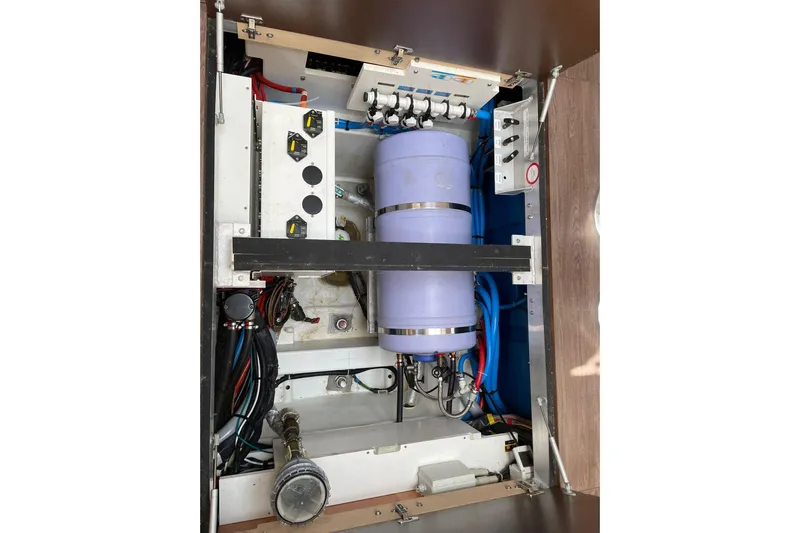  Yacht Photos Pics Engine compartment of 2017 Jeanneau 64 yacht, showcasing mechanical components and wiring.