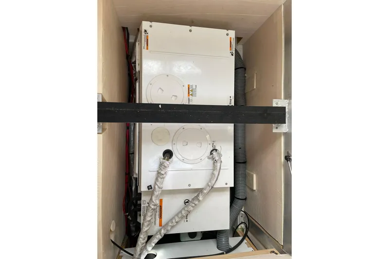  Yacht Photos Pics Engine compartment of a 2017 Jeanneau 64 yacht, showcasing mechanical components and wiring.