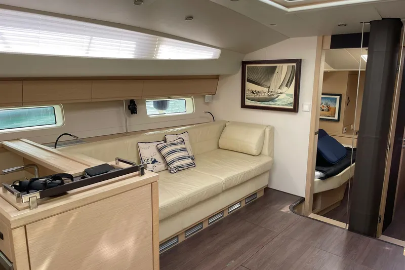  Yacht Photos Pics Luxurious interior of 2017 Jeanneau 64 yacht with elegant seating and nautical decor.