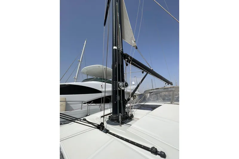  Yacht Photos Pics 2017 Jeanneau 64 sailboat deck with mast and rigging in marina.
