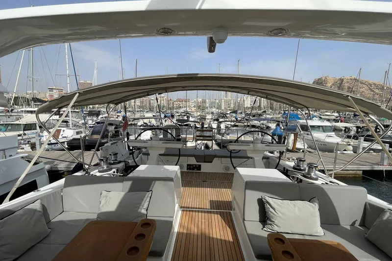  Yacht Photos Pics Luxurious 2017 Jeanneau 64 yacht interior at marina, showcasing elegant seating and helm.