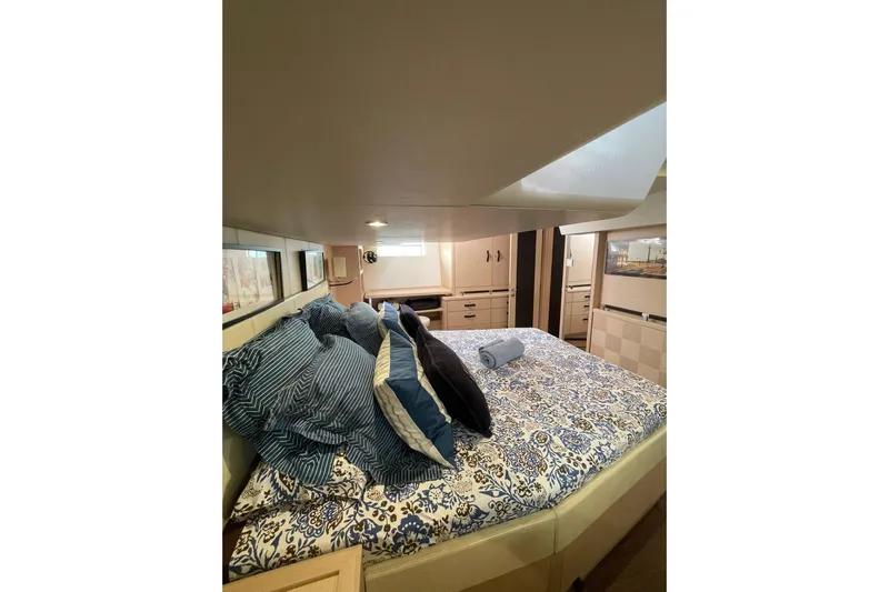  Yacht Photos Pics Luxurious cabin interior of 2017 Jeanneau Yachts JEANNEAU 64 with elegant bedding and decor.