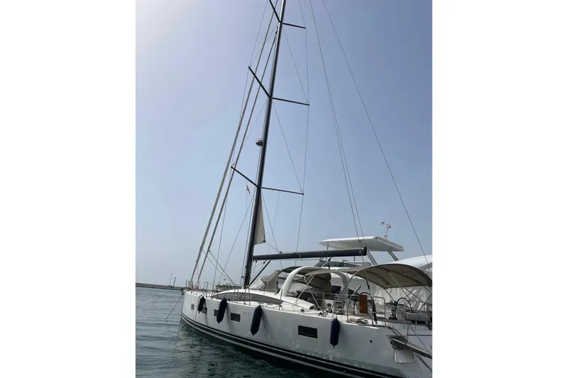  Yacht Photos Pics 2017 Jeanneau Yachts JEANNEAU 64 sailboat docked in calm waters.