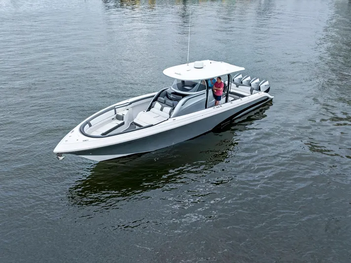  Yacht Photos Pics 2020 Fountain 43NX boat on calm water, featuring sleek design and multiple outboard engines.