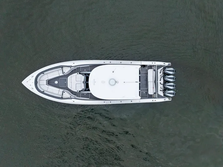  Yacht Photos Pics Aerial view of 2020 Fountain 43NX boat on water, showcasing sleek design and multiple engines.
