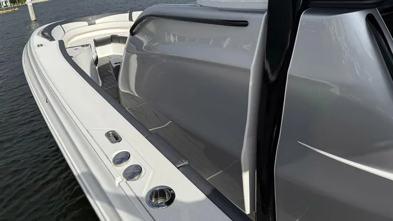  Yacht Photos Pics 2020 Fountain 43NX boat, sleek design, white and gray exterior, docked on water.