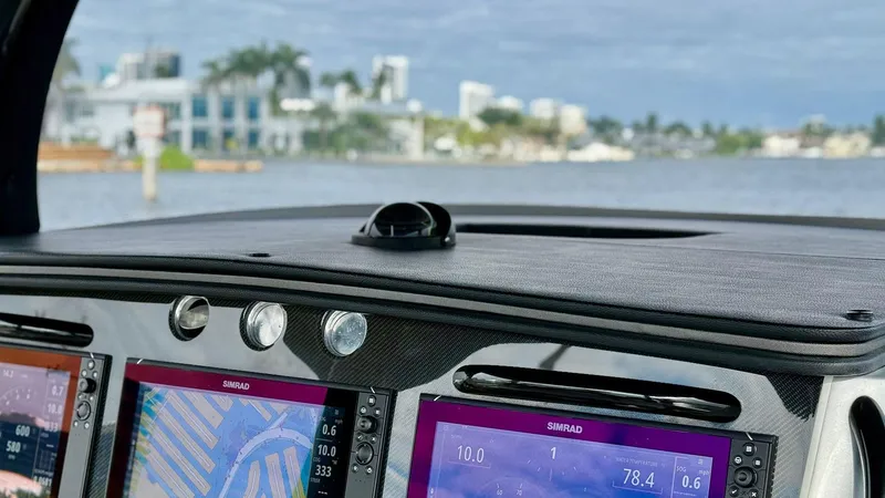  Yacht Photos Pics Dashboard of 2020 Fountain 43NX boat with navigation screens, overlooking waterfront view.