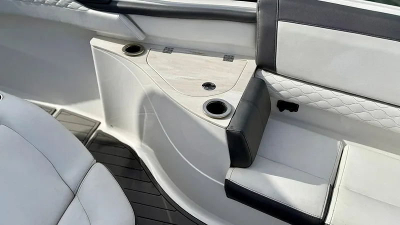  Yacht Photos Pics Interior seating of a 2020 Fountain 43NX boat with cup holders and cushioned seats.