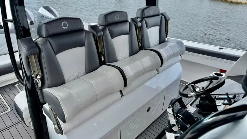  Yacht Photos Pics 2020 Fountain 43NX boat interior with luxurious seating and steering wheel.