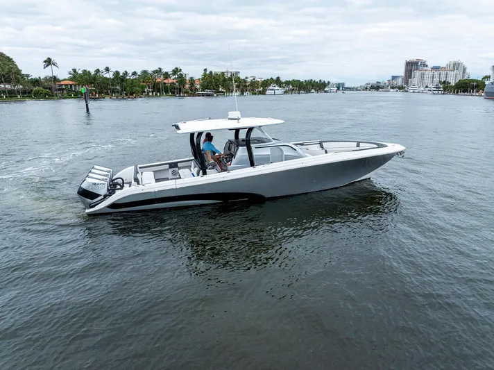  Yacht Photos Pics 2020 Fountain 43NX boat cruising on a calm waterway with scenic background.