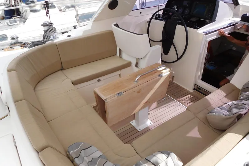  Yacht Photos Pics Luxurious 2011 Amel 55 yacht cockpit with beige seating and modern steering area.