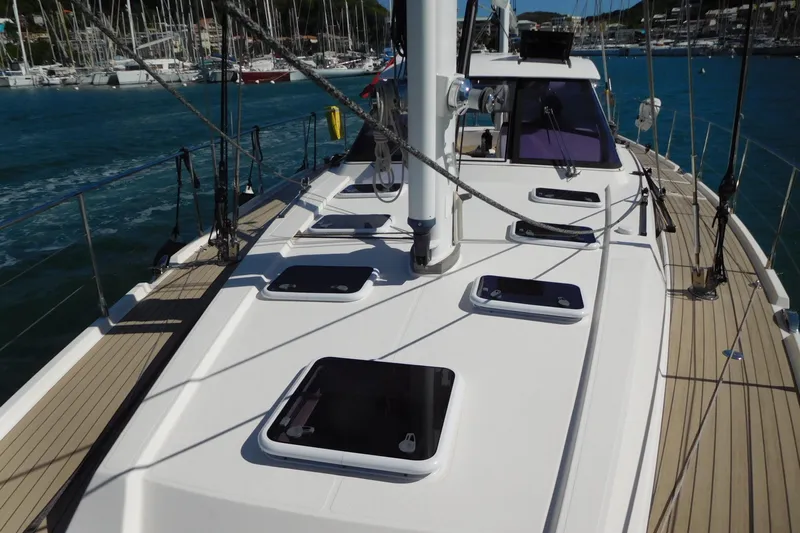  Yacht Photos Pics Sailing yacht Amel 55, 2011 model, docked in a marina with clear blue water.